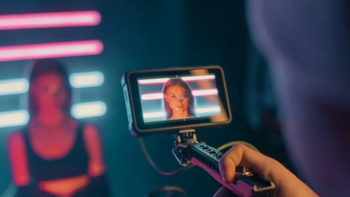 Phone on a camera rig filming a vertical video of a woman under neon lights for Instagram Reels