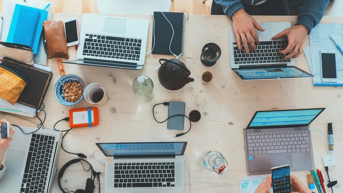A marketing team working on several laptops around a wooden table