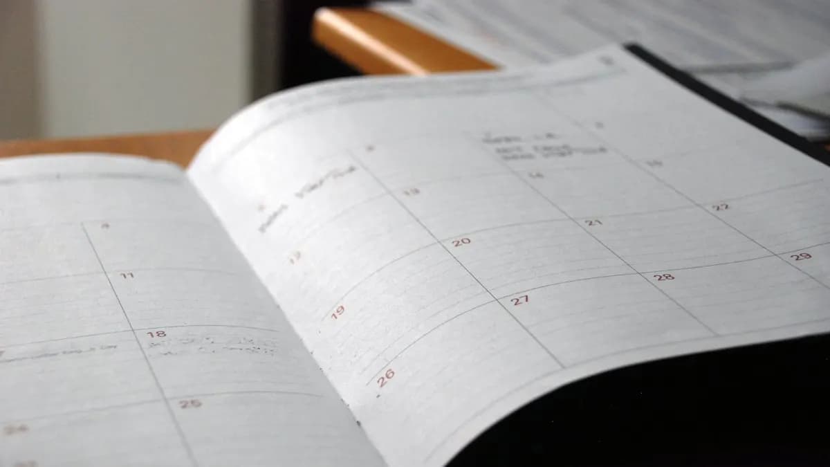 Open monthly planner on a wooden desk used to plan a digital marketing course