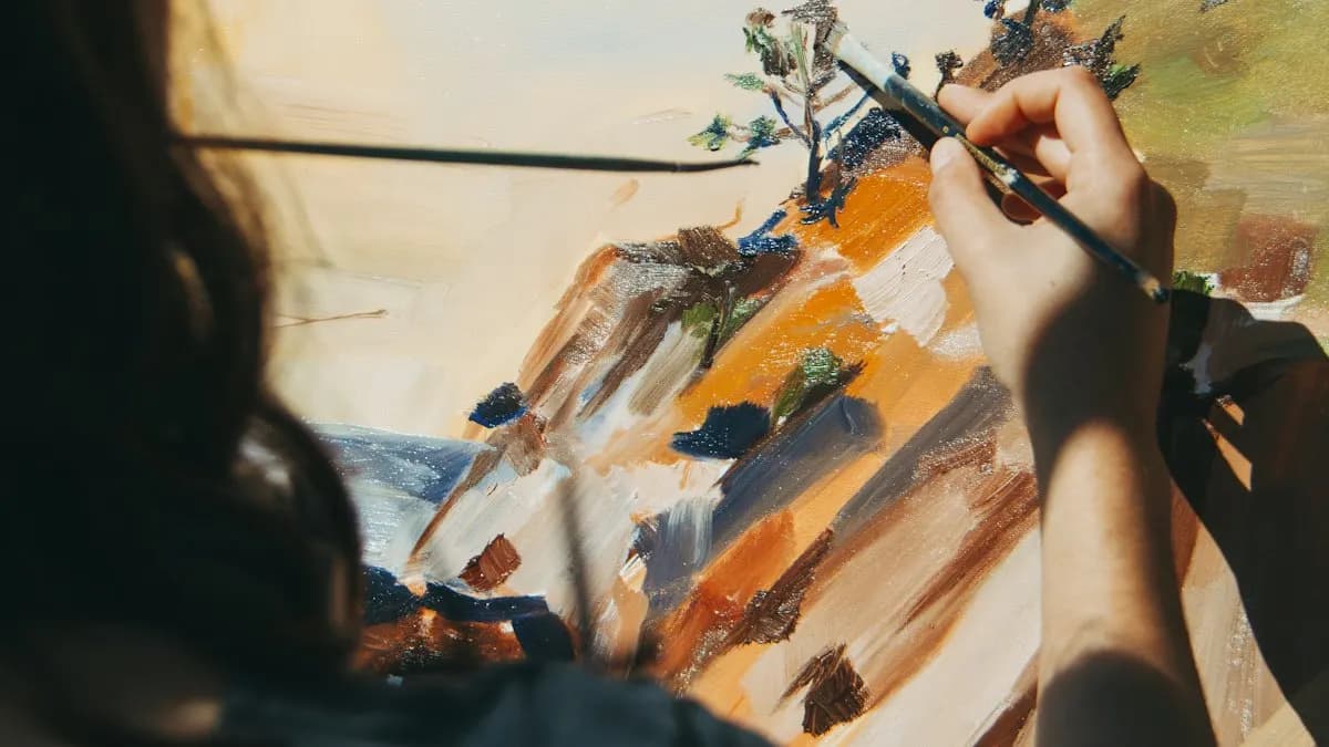 Art student painting a hillside scene with a fine brush on canvas, palette of oil colours beside her