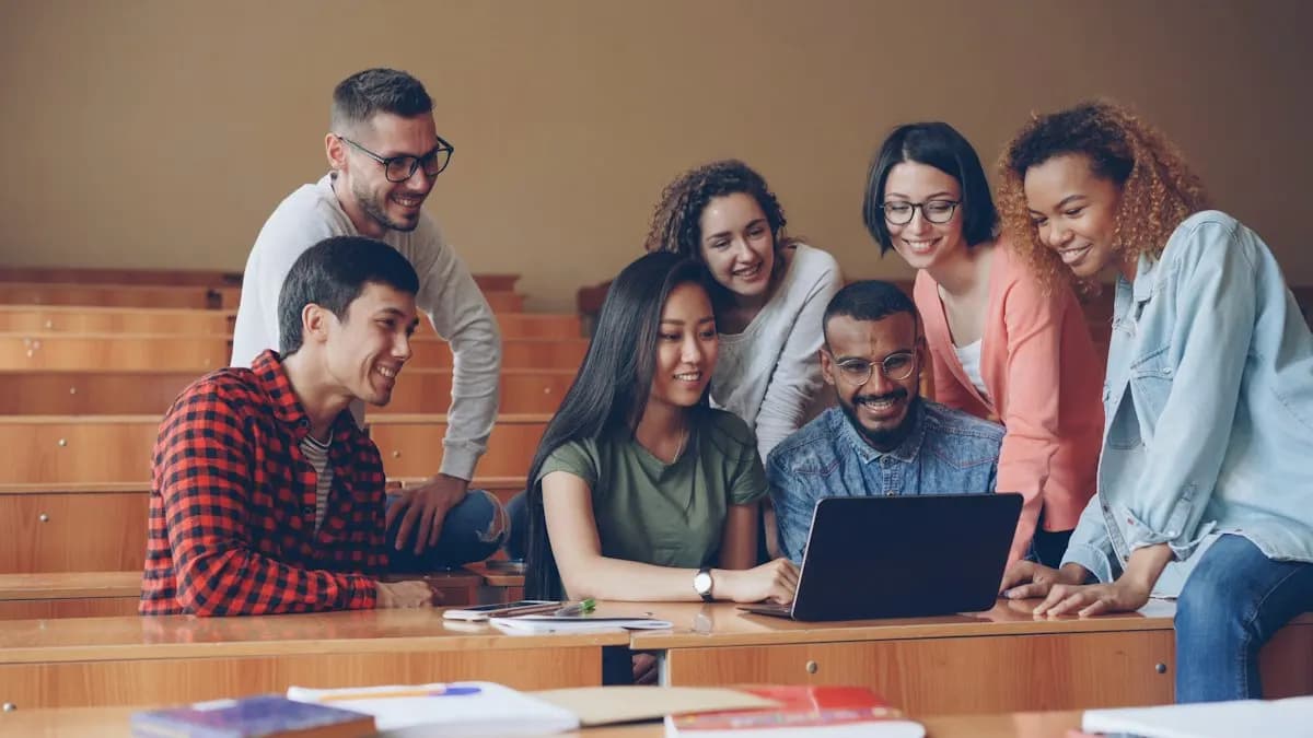 Group of students around a laptop in a classroom during a graphic design class