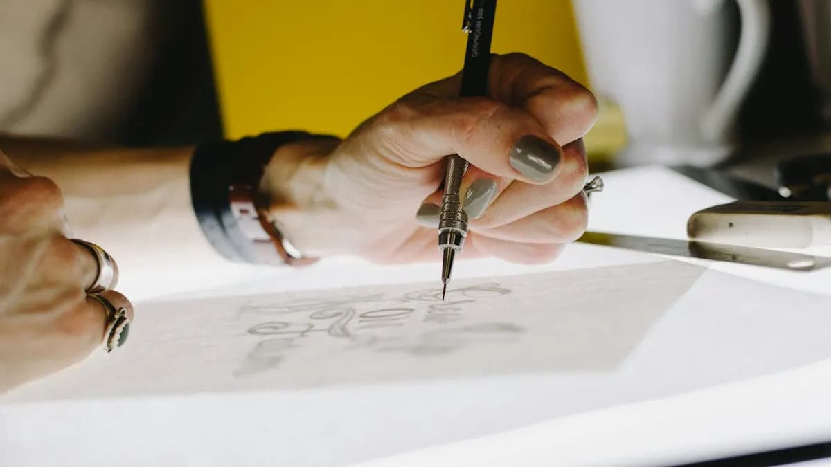 Beginner designer sketching letter shapes on tracing paper with a mechanical pencil