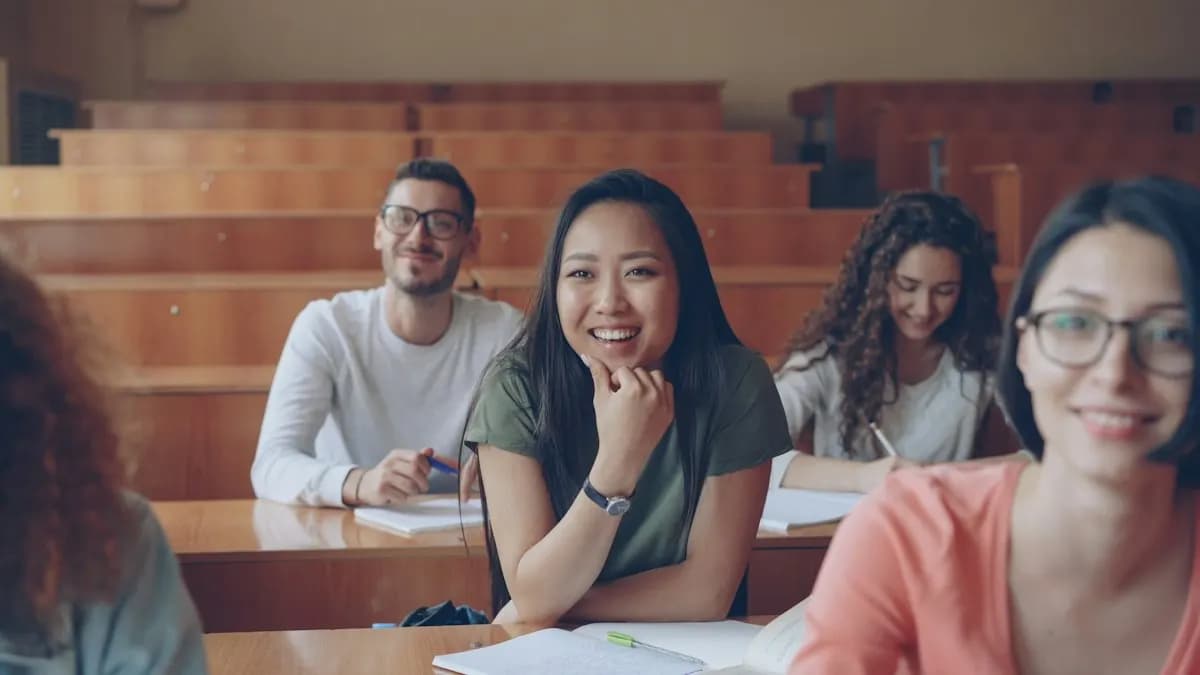 Smiling college students sitting together in a lecture hall after 12th