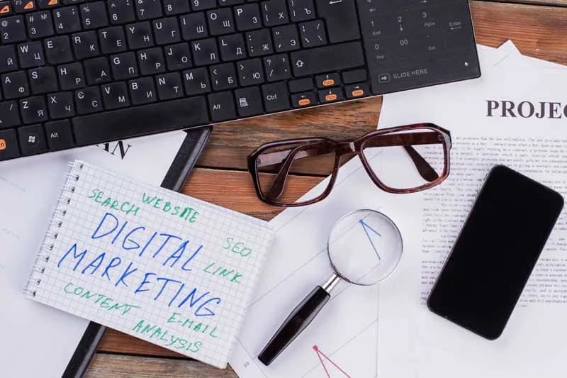 Digital marketer reviewing salary and campaign data on a laptop