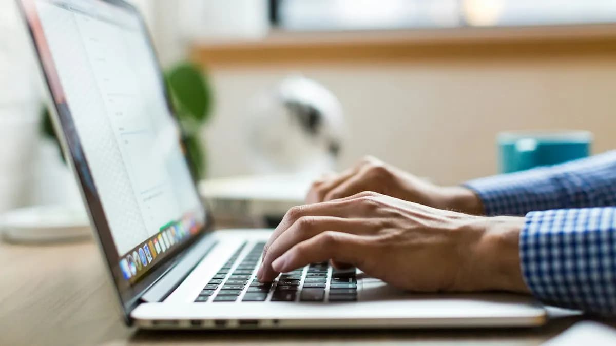 Person typing on a laptop while studying an online digital marketing certificate course