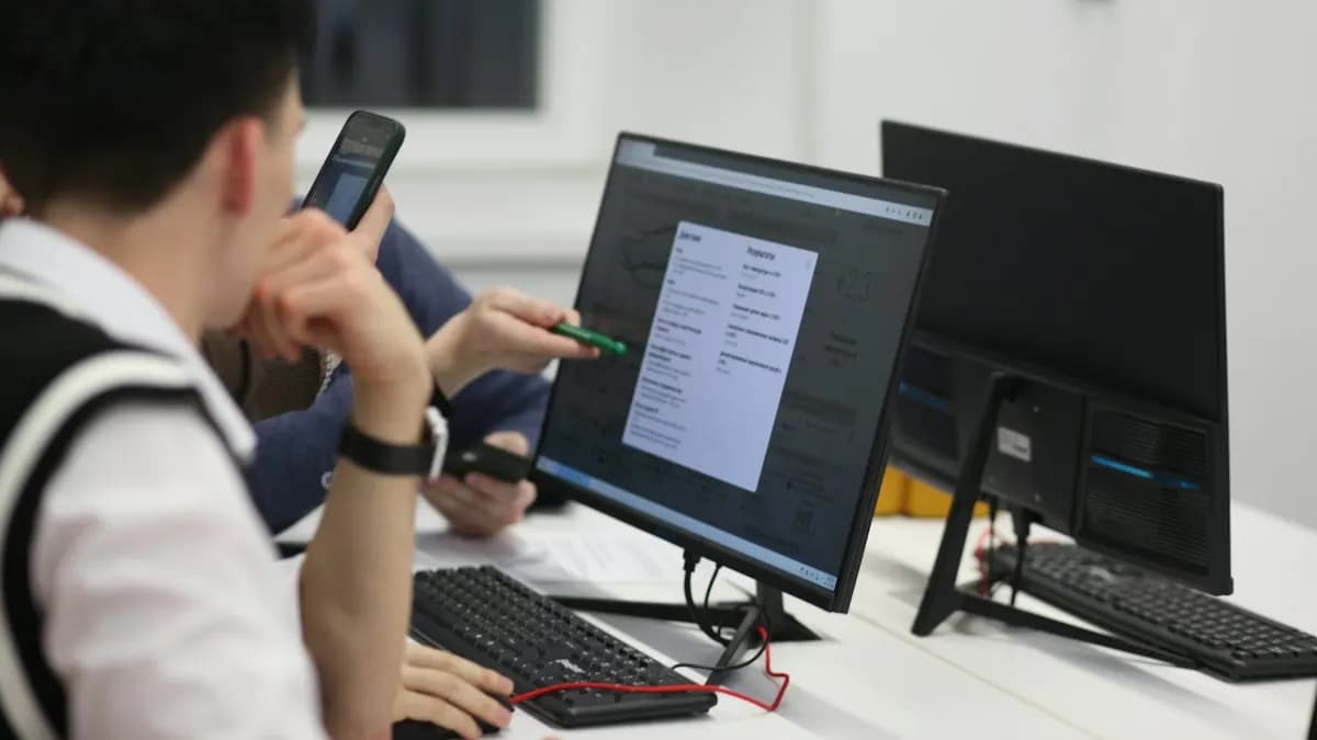 Students working on desktop computers in a bright training room at a design institute