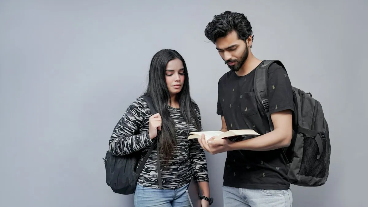 Two college students after 12th looking at a notebook together while planning their course