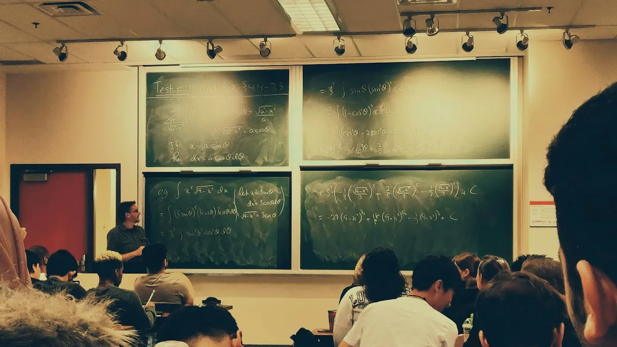 Students seated in a college lecture room facing a teacher at large green chalkboards