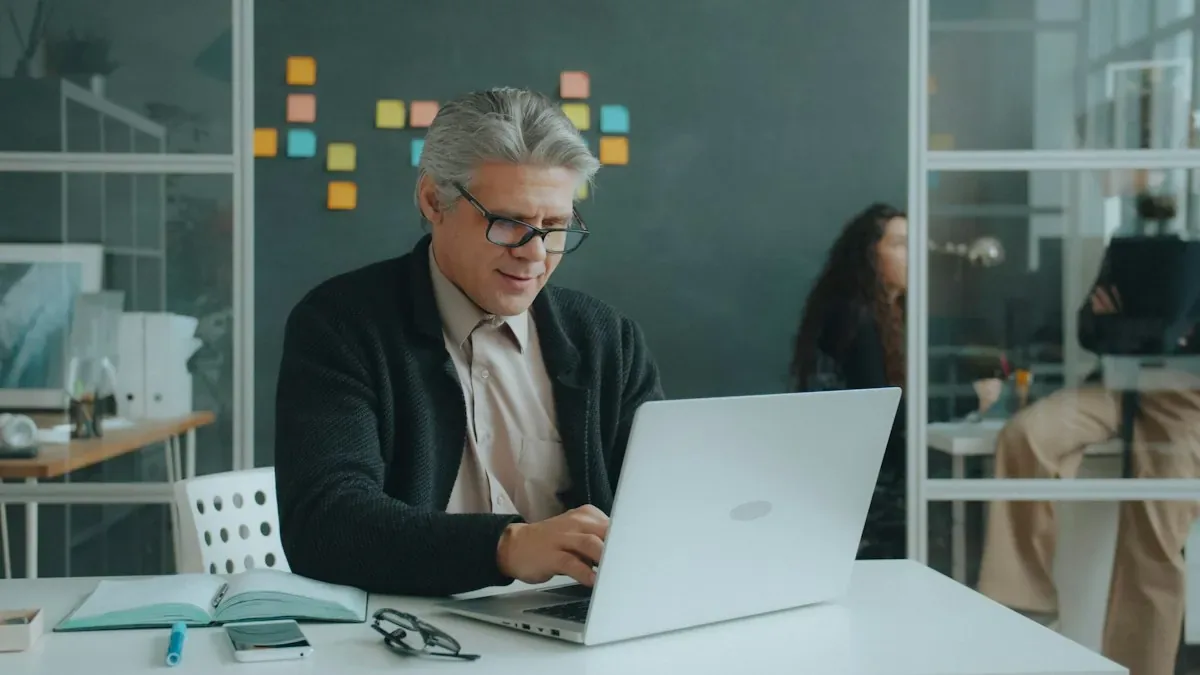 A mature professional learning on a laptop at a desk