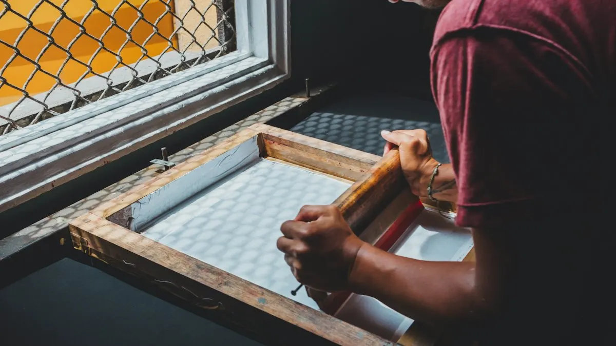Screen printer pulling ink across a mesh screen, a common CorelDRAW vs Illustrator print job