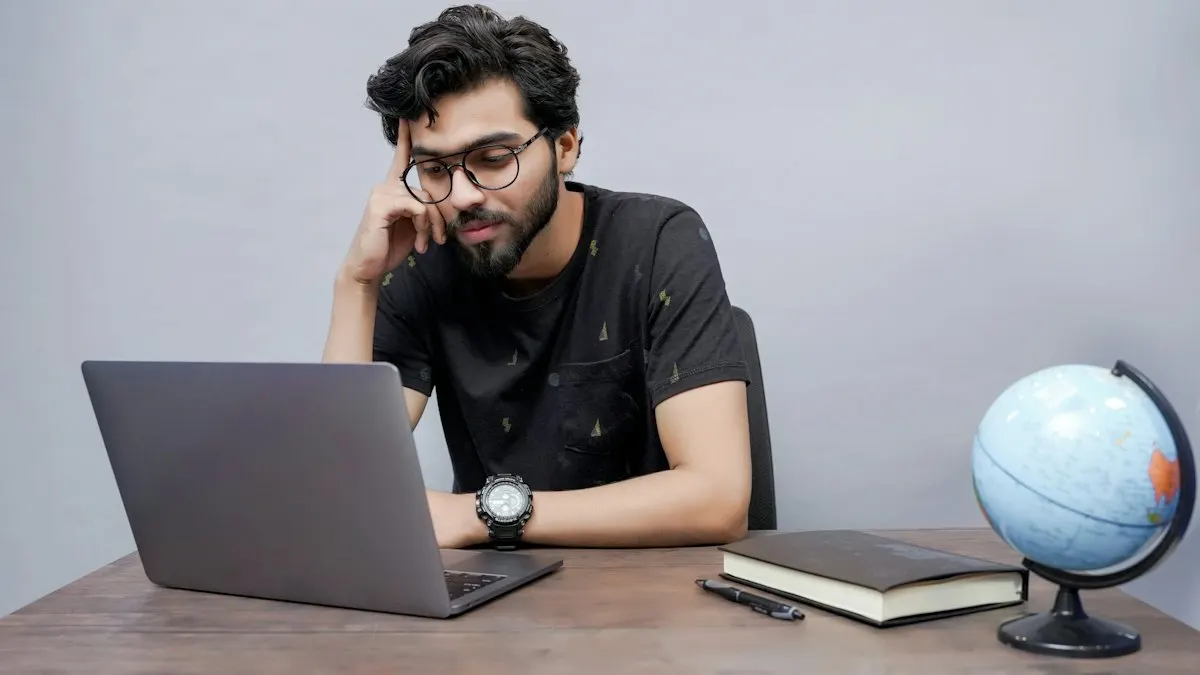 Young student working on a laptop at a desk planning a digital marketing campaign