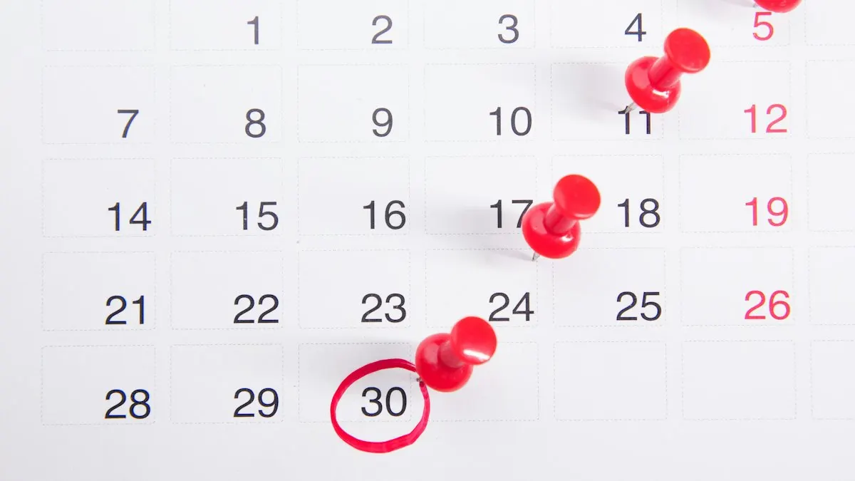 Wall calendar with red push pins marking dates for a digital marketing study plan