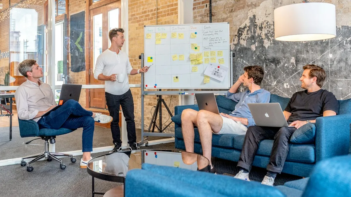 A team discussing marketing results around a table with laptops