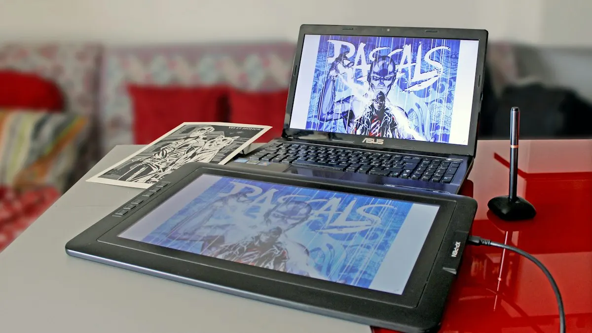 Graphic design student workstation with a pen display tablet and laptop showing a poster design