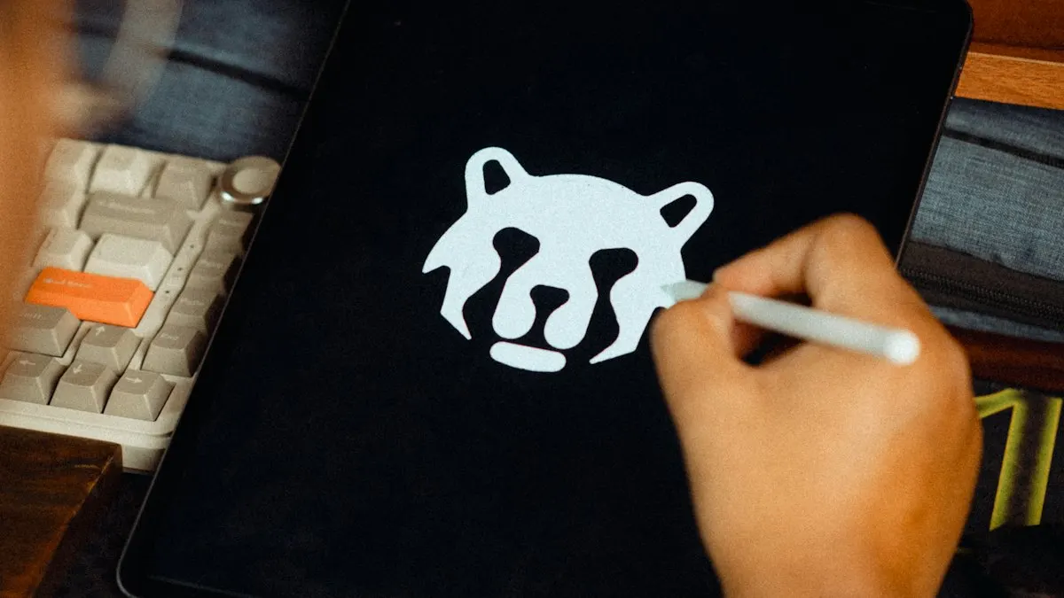 Designer drawing a white bear logo with a stylus on a dark tablet screen