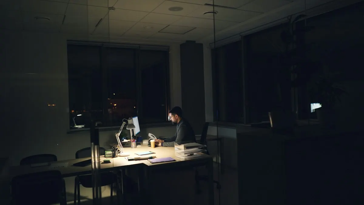 Man working late at a desk in a quiet office after hours on design practice