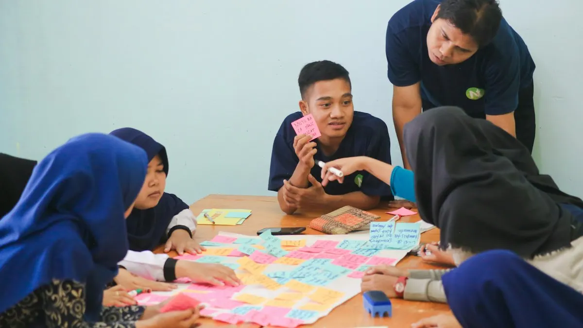 Students working together around a table on a design project in a classroom