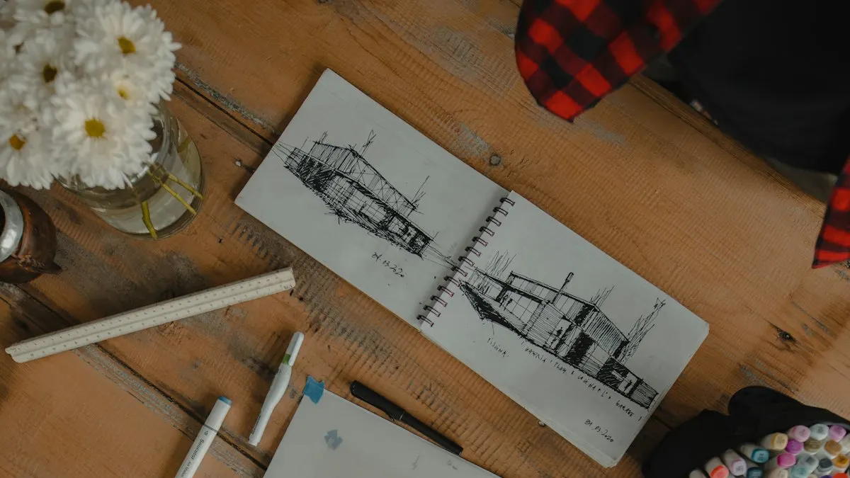 Open sketchbook with pencil architecture drawings on a wooden table with markers
