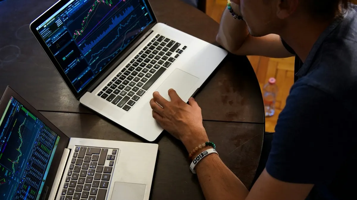 Two laptops on a dark table showing marketing dashboards and charts