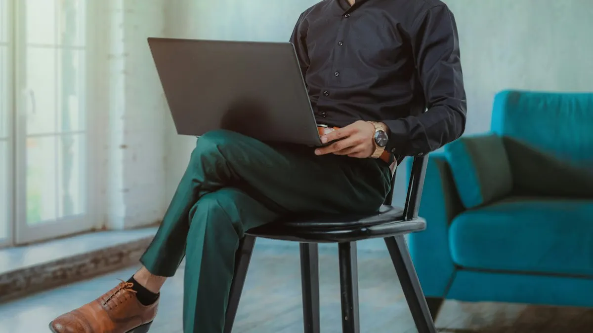 Man sitting on a chair with a laptop planning a digital marketing project