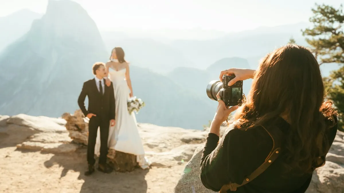 Bride and groom posing for a photographer at an outdoor wedding shoot
